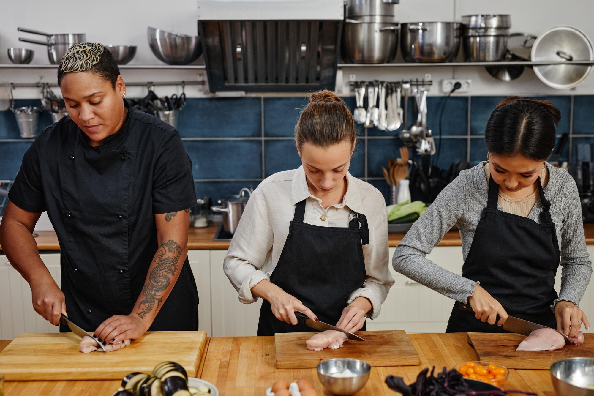 Team preparing dishes in studio kitchen